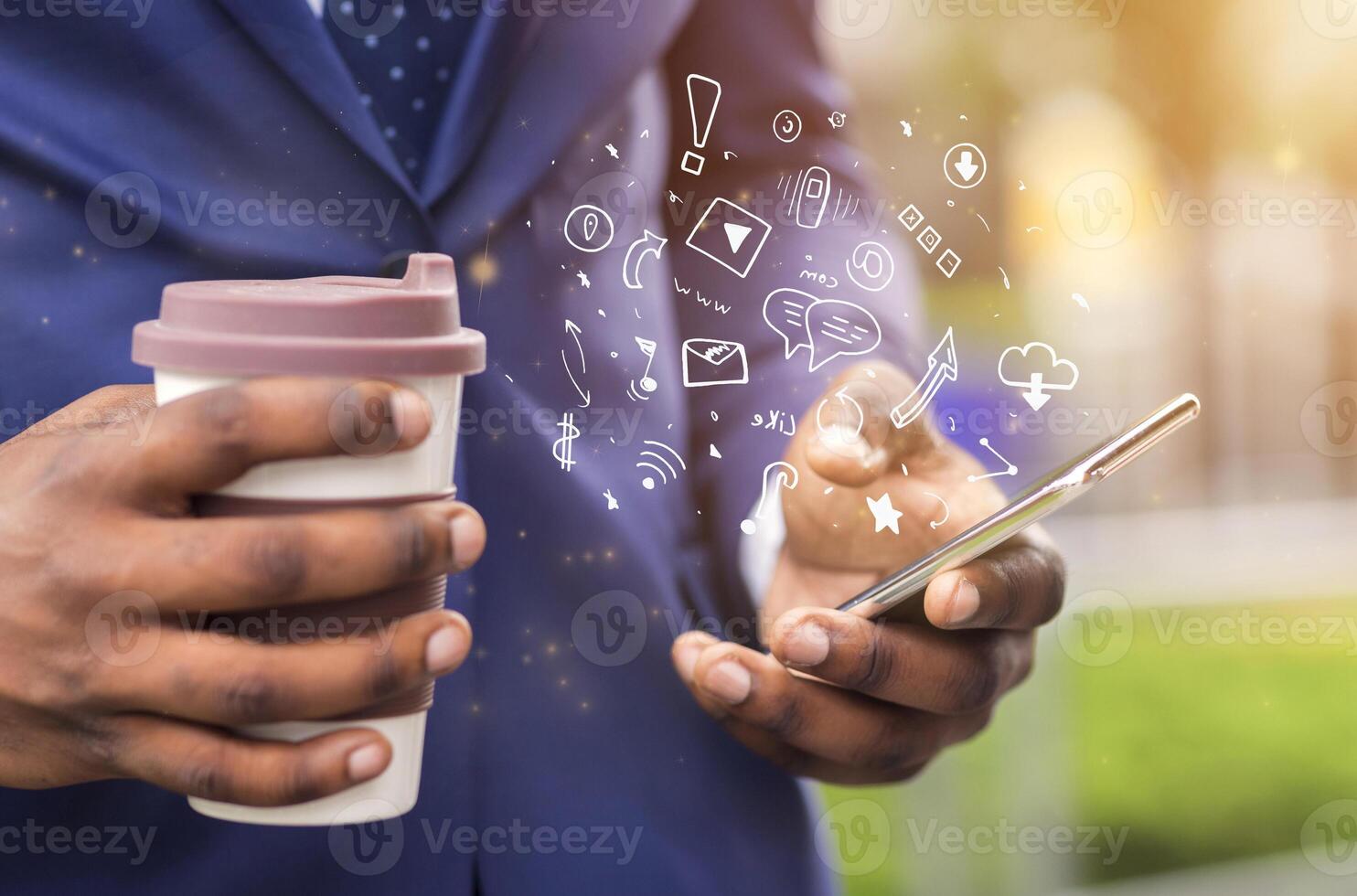 Close up of african businessman holding coffee to go and using brand new mobile phone with functional icons photo