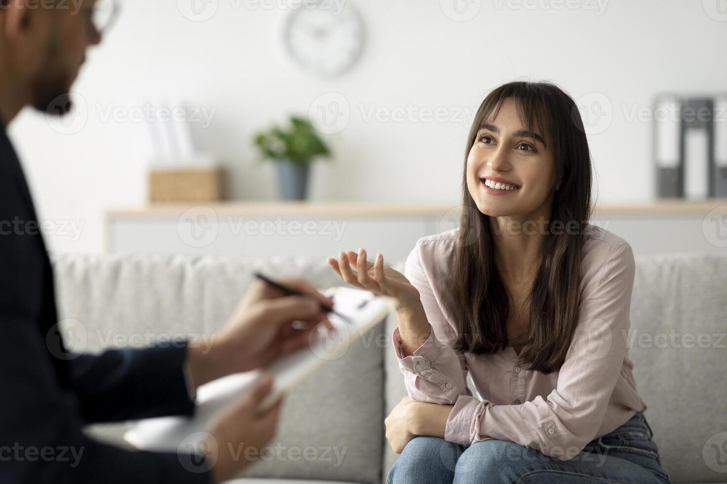 Successful therapy. Arab female client having consultation with psychologist, grateful for professional help. Happy lady speaking with her psychotherapist, solving emotional problem photo