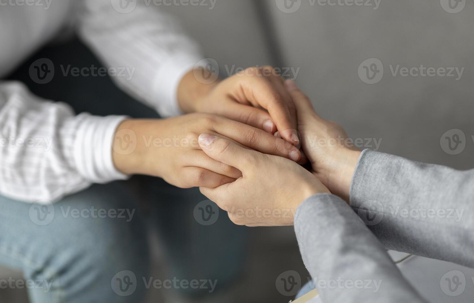 Psychological support. Psychotherapist offering help to young woman, holding her hands during psychotherapy session, closeup. Unrecognizable psychiatrist providing assistance to female patient photo