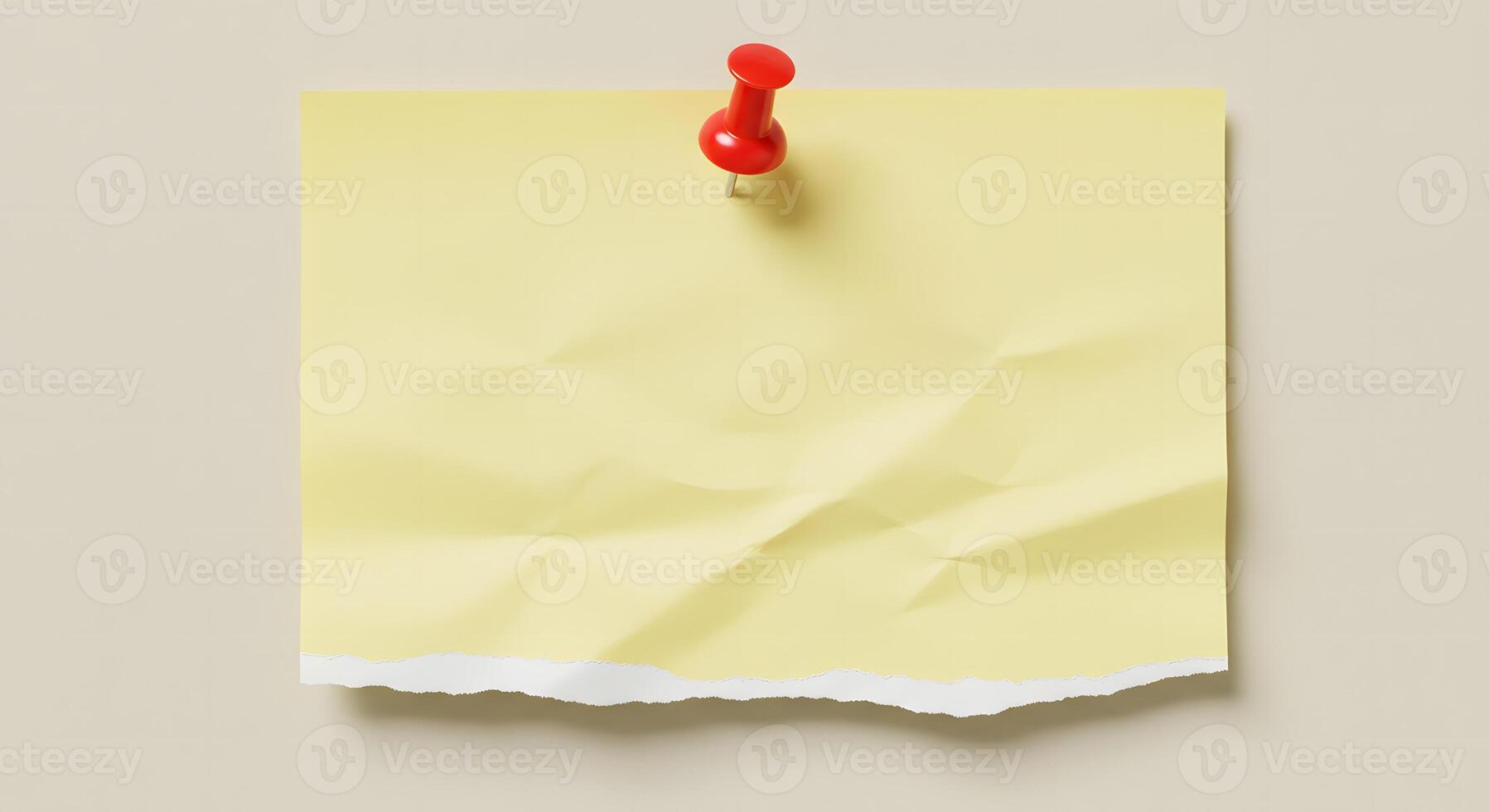 Yellow Torn Paper Pinned on Wall for Message or Reminder photo