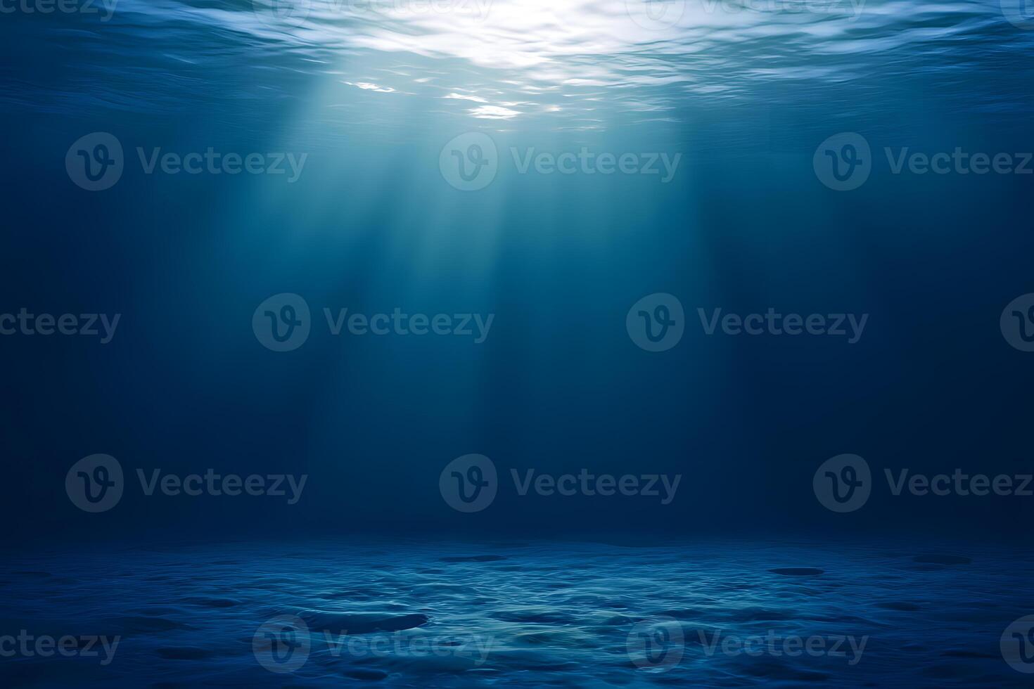 Deep ocean view with sunlight streaming through water, illuminating a vast empty ocean floor and open space for text photo