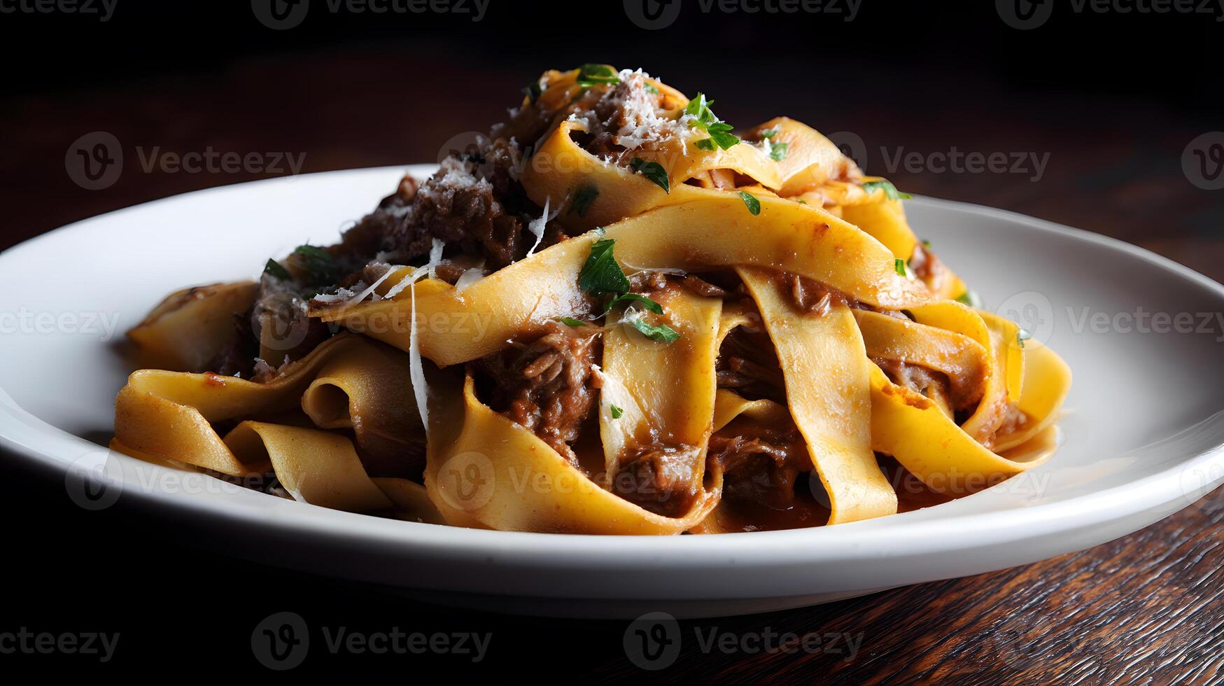 Italian pappardelle pasta coated in rich beef ragu sauce with chunks of tender meat and fresh herbs garnish photo