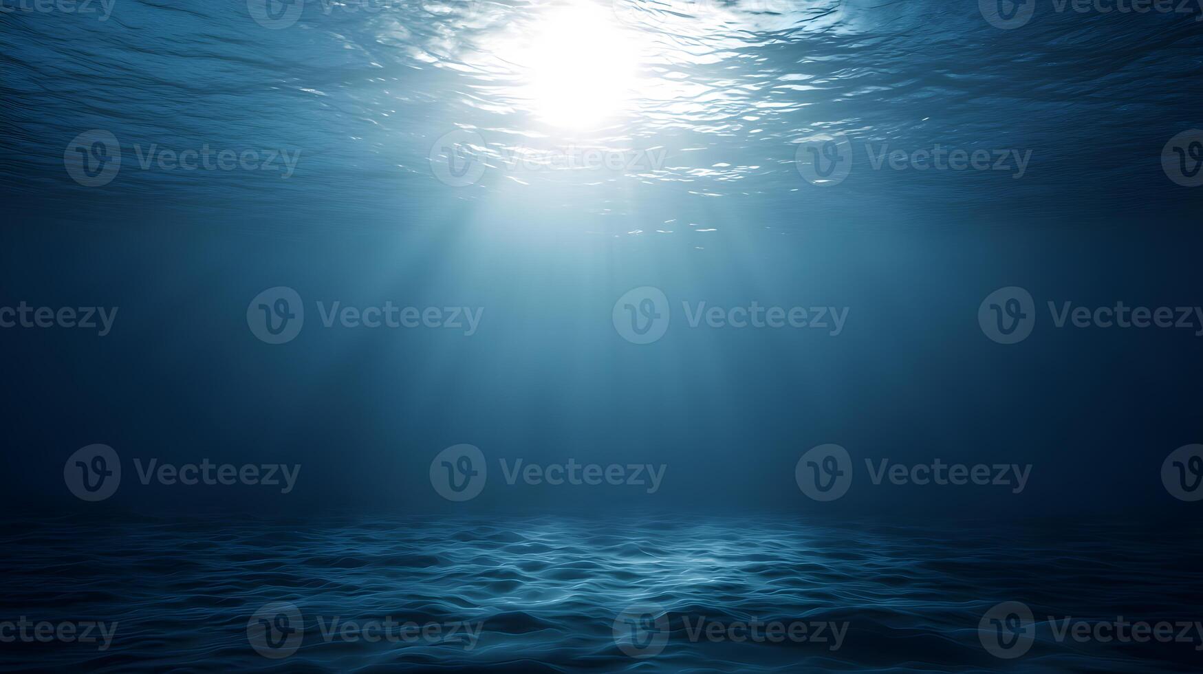 Bright sunlight penetrating deep ocean water, casting soft beams on an expansive empty ocean floor with ample blank space photo