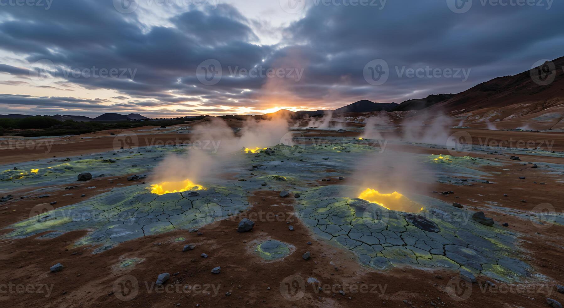 Geothermal Area with Steam Vents and Colorful Landscape at Sunset photo
