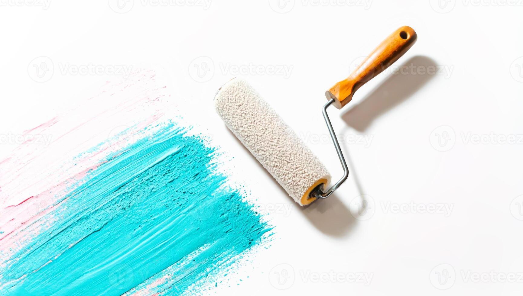 Paint roller applying vibrant turquoise stroke on white surface photo