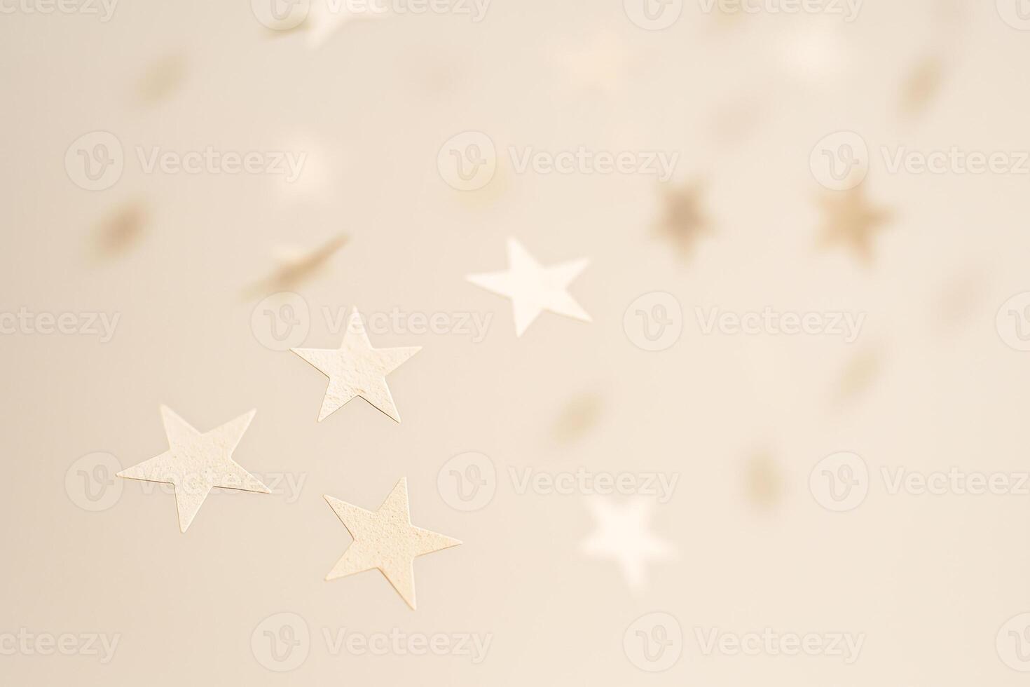 Soft Floating Paper Stars In Neutral Tones On Beige Background photo