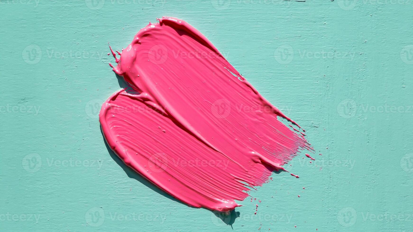 Bold pink brushstrokes on textured turquoise background photo