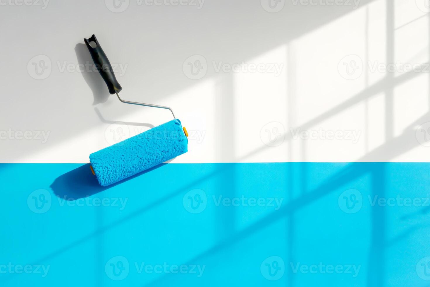 Paint roller applying bold blue coat on white wall, creating sharp color contrast photo