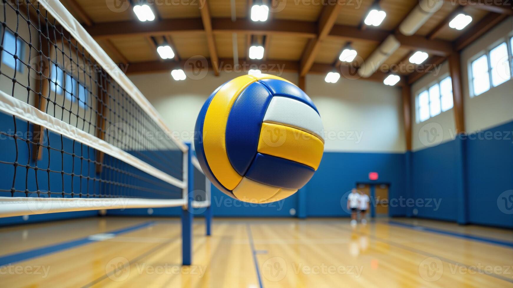 Volleyball Flying Over Net In Gymnasium photo