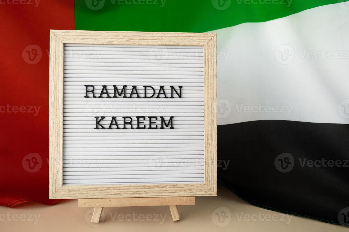 Message text RAMADAN KAREEM - happy holidays waving UAE flag on background concept. Greeting card advertisement. Commemoration Day Muslim Blessed holy month public holiday photo