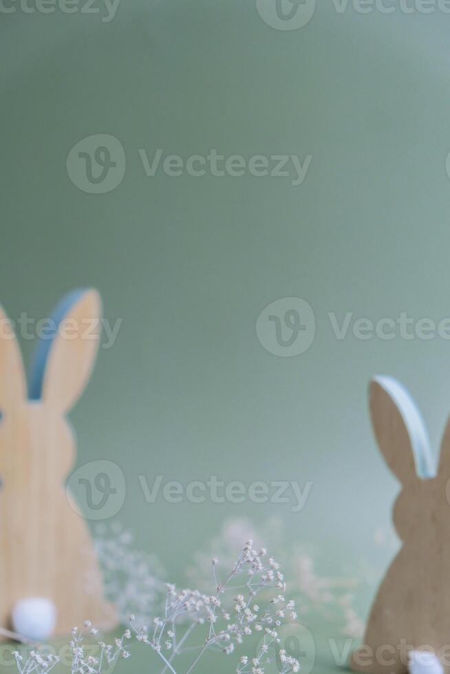 Defocused background Wooden minimalism low-key bunny decor in pastel green background. Sustainable holiday minimalistic still life composition. Copy space template for invitation greeting card postcard photo