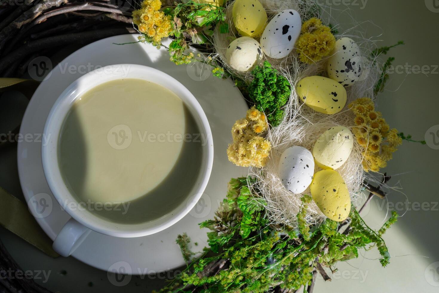 Easter egg wreath holiday decor Nutrient-rich matcha drink with macaron dessert and trendy deep shadows on soft colored background. Morning beautiful breakfast present gift idea. Vibrant creative colors. Natural energy givers tea photo