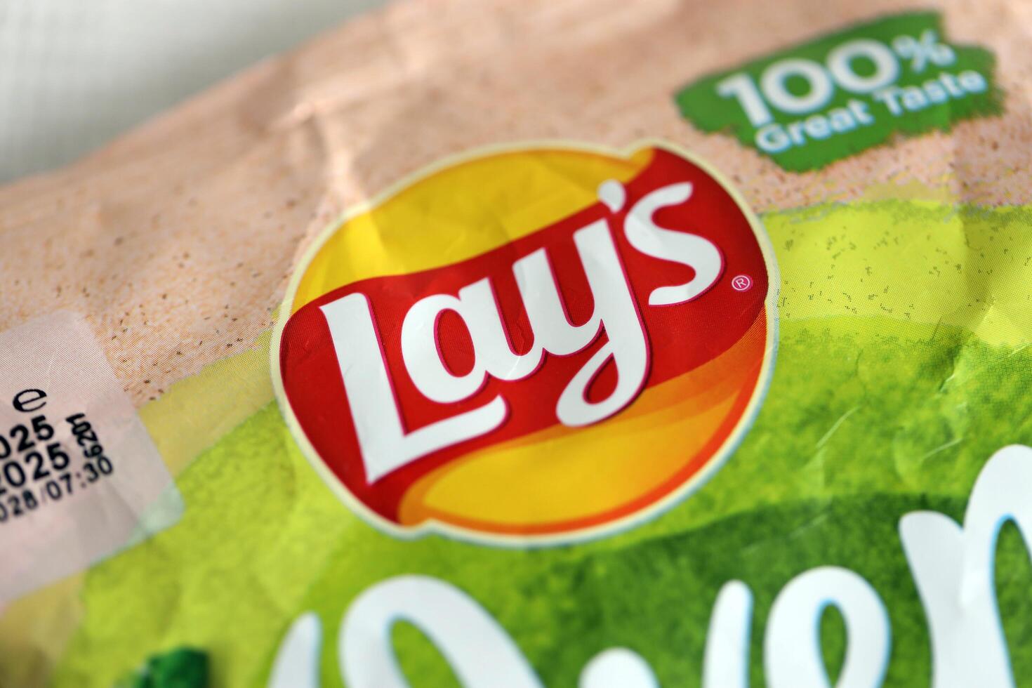 KYIV, UKRAINE - APRIL 19, 2025 Lays Oven Baked Yoghurt with herba flavoured potato chips in green pack with Lays logo photo