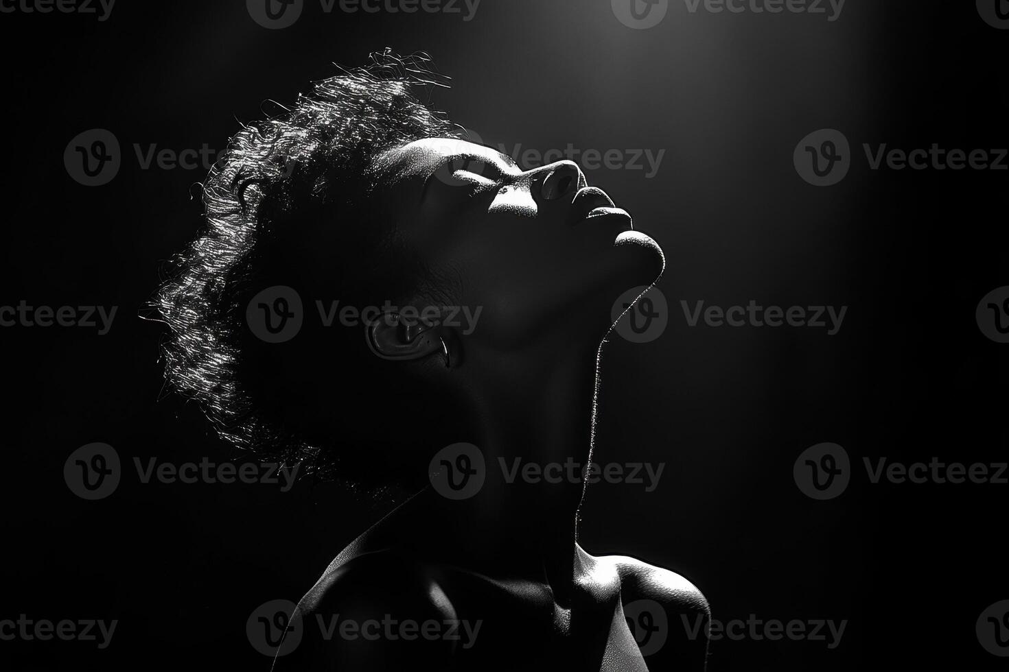 Black and white portrait of a young woman with afro hair posing in a smoky atmosphere, creating a dramatic and stylish image photo