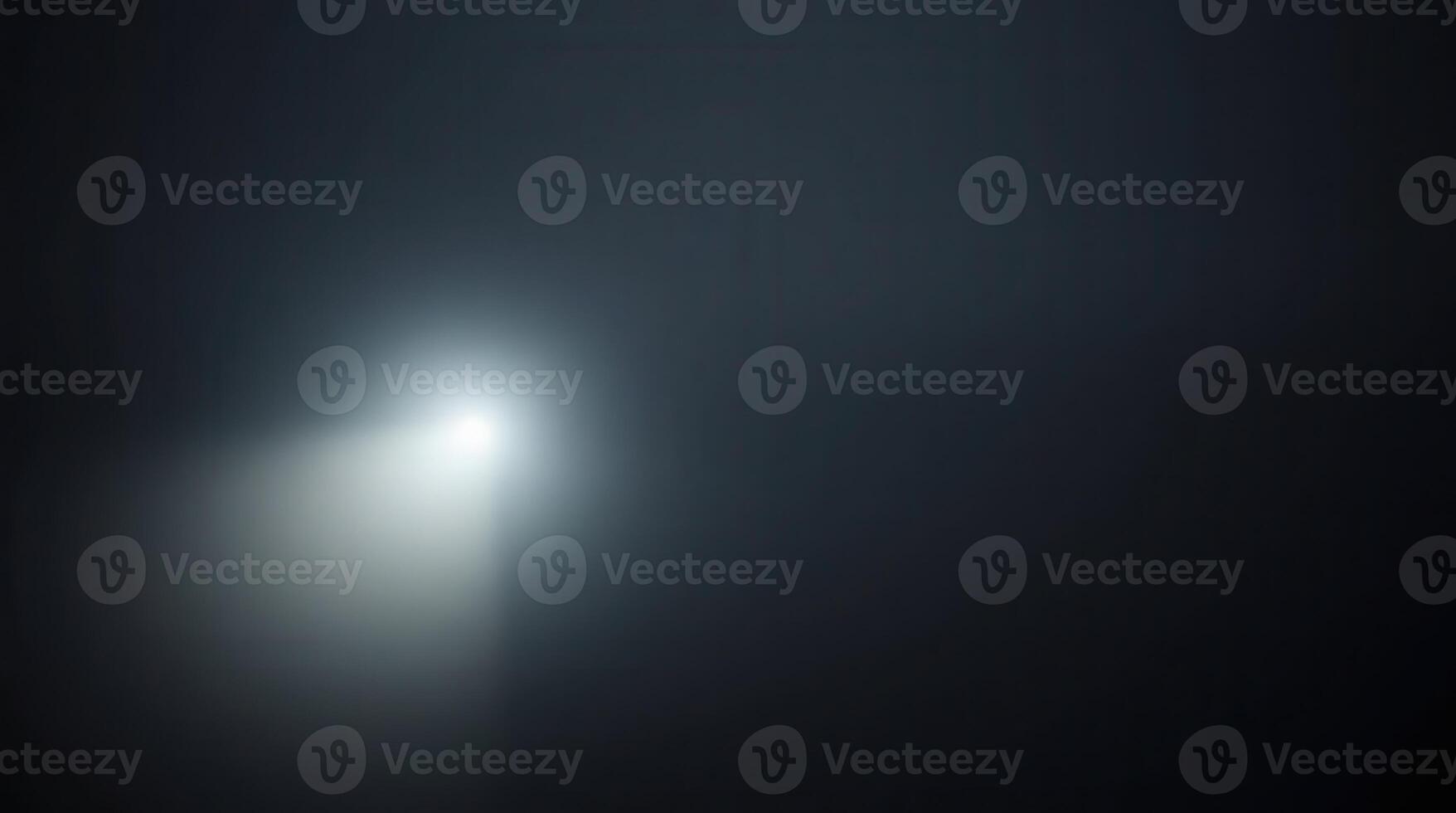 a soft, diffused beam of light gently illuminates the darkness, creating an ethereal and mysterious atmosphere photo