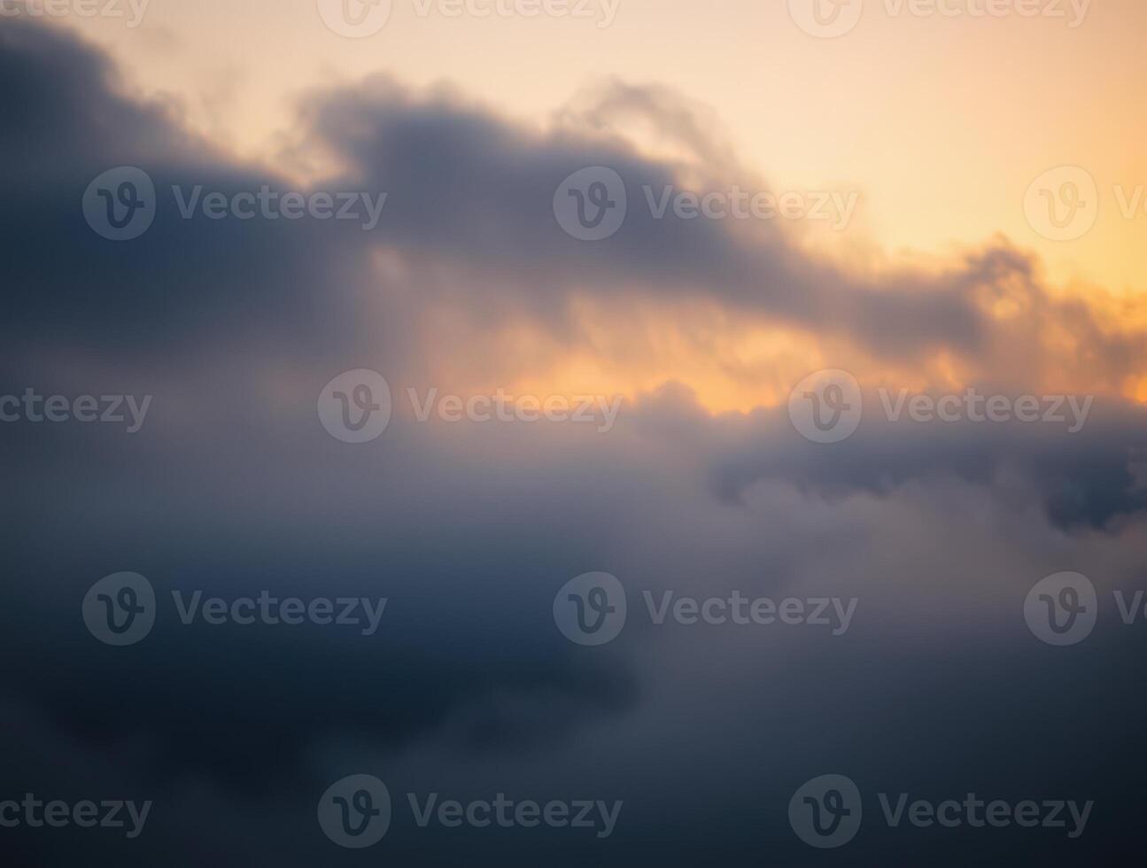Golden hour cloudscape above the clouds. A breathtaking view of a dramatic sky at sunset, showcasing the beauty of nature's colors. photo