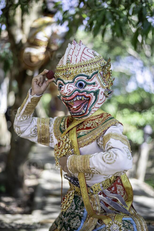 Khon is a rare Thai cultural performance. The image shows a white monkey's head with fruit in its hand. photo