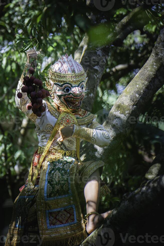 Khon is a rare Thai cultural performance. The image shows a white monkey's head with a large bunch of fruits in its hand. photo
