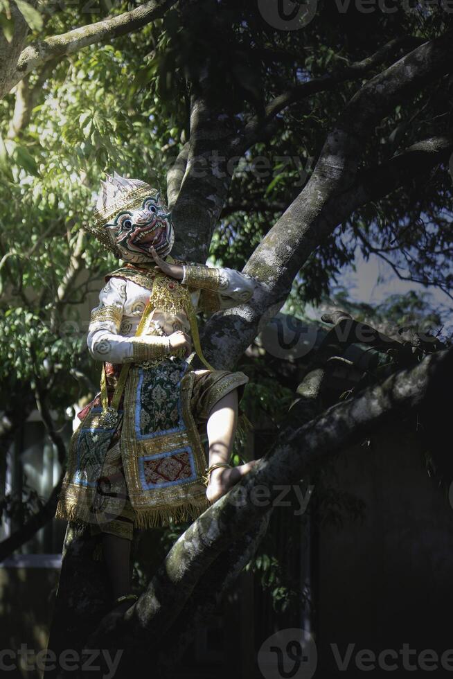Khon is a rare Thai cultural performance. The image shows the head of a white monkey climbing a tree. photo