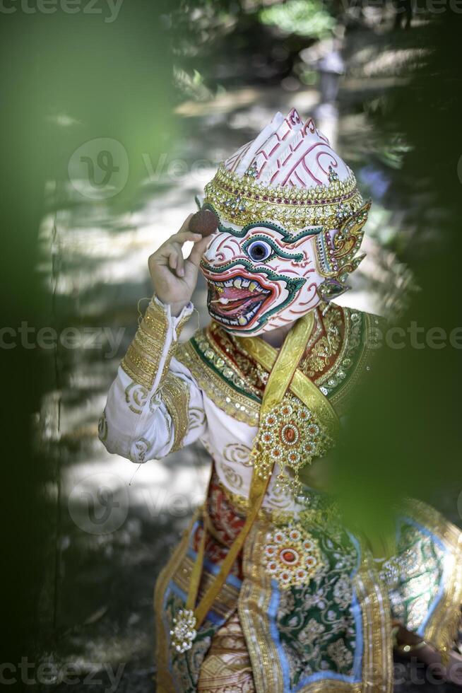 Khon is a rare Thai cultural performance. The image shows the head of a white monkey looking at fruit. photo