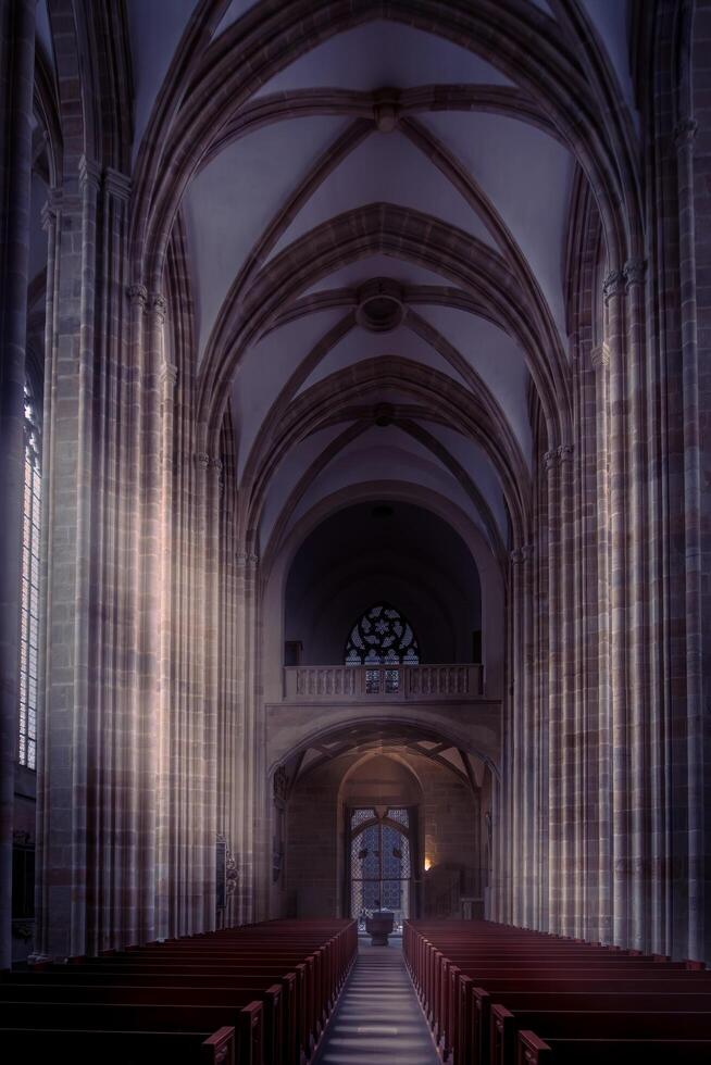 Meissen, Germany-august 17, 2022-Central nave with very tall columns, arches and benches inside the Maissen Cathedral during the day photo
