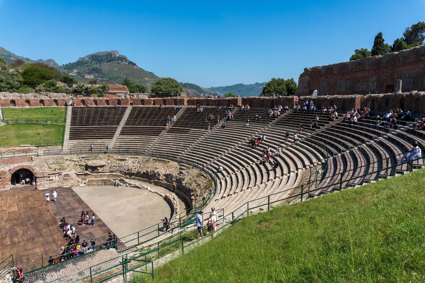 Sicily, Italy-May 12, 2022-tourists admire the great ancient theatre of Taormina during a sunny day photo