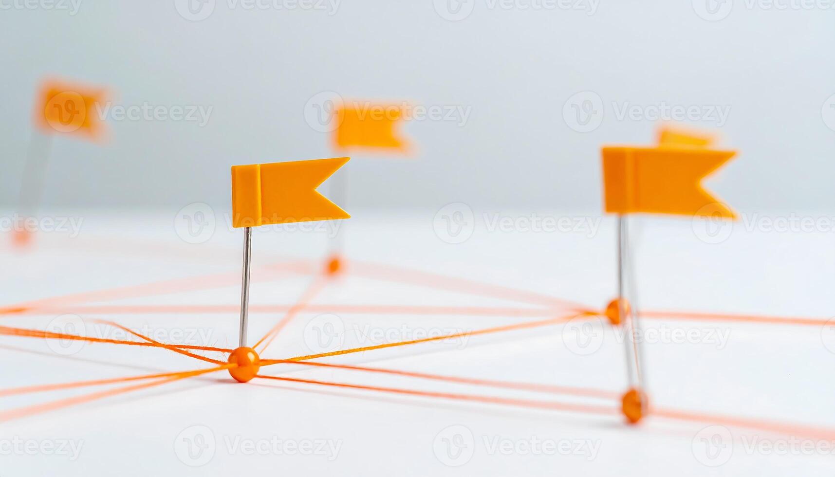Orange Thread, Pins, and Flags Representing Stages of Goal Achievement and Planning photo
