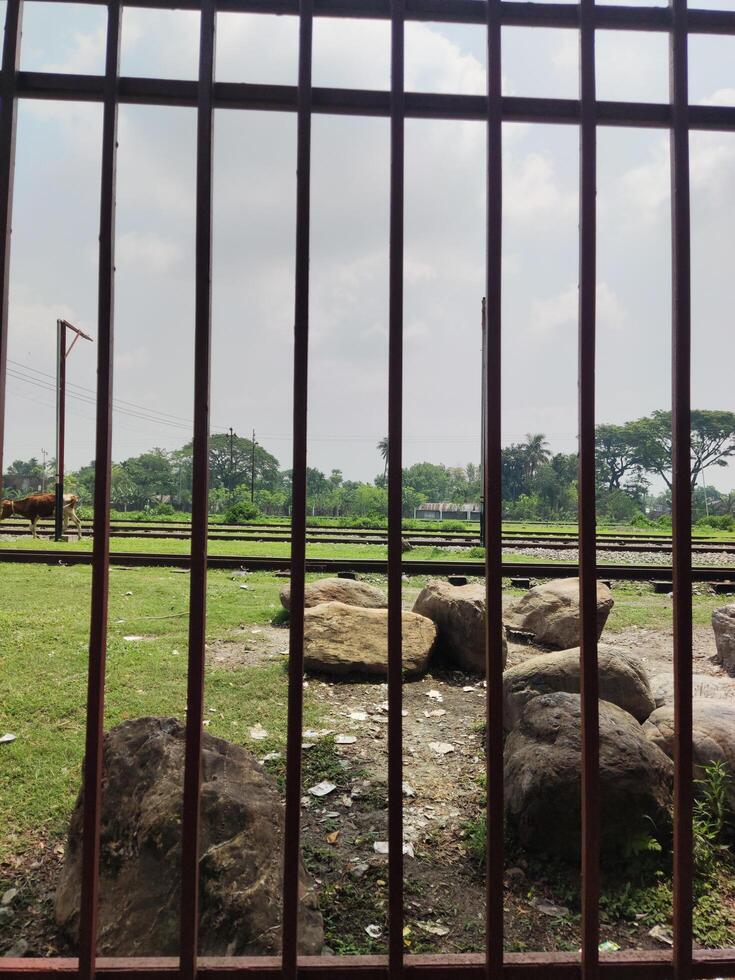 View of a railway track through a fence photo