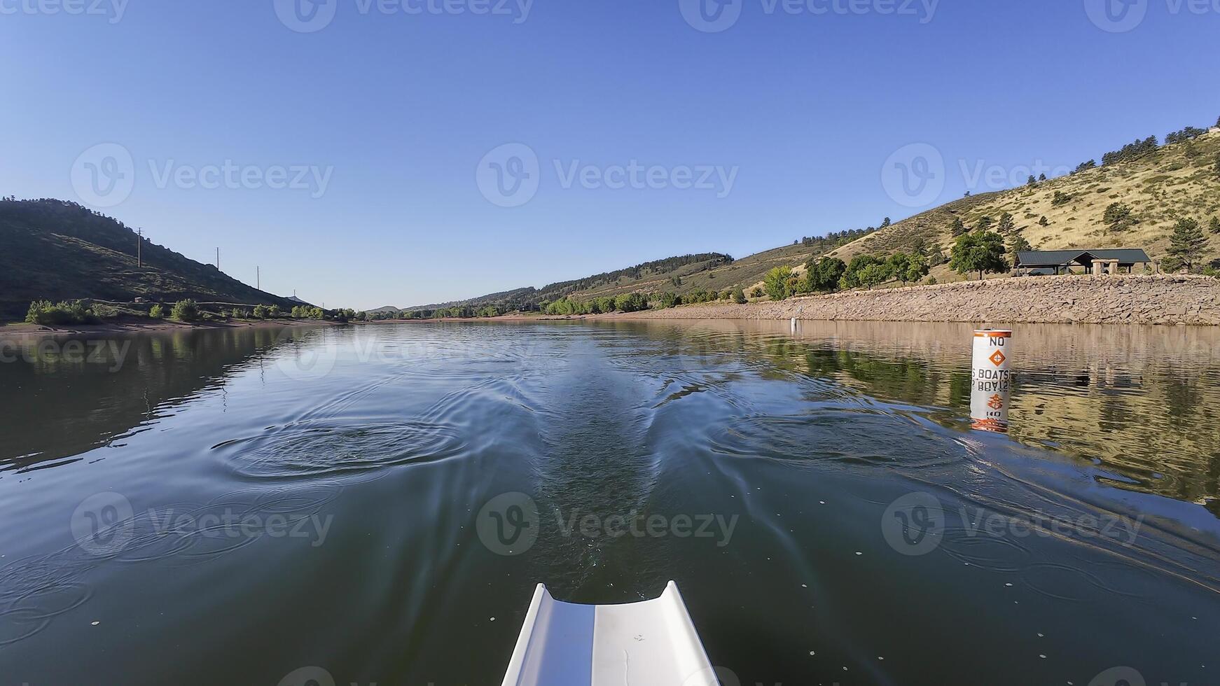 morning rowing on calm water of Horsetooth reservoir in Colorado - POV rower perspective photo