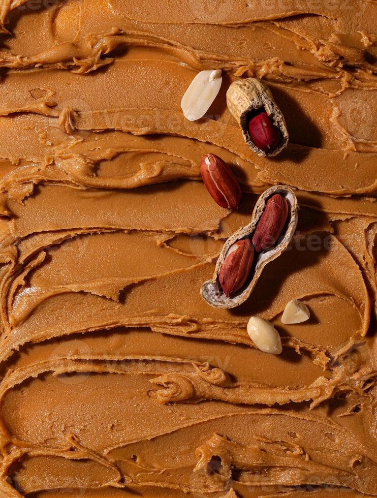 Peanut butter texture background and nuts photo