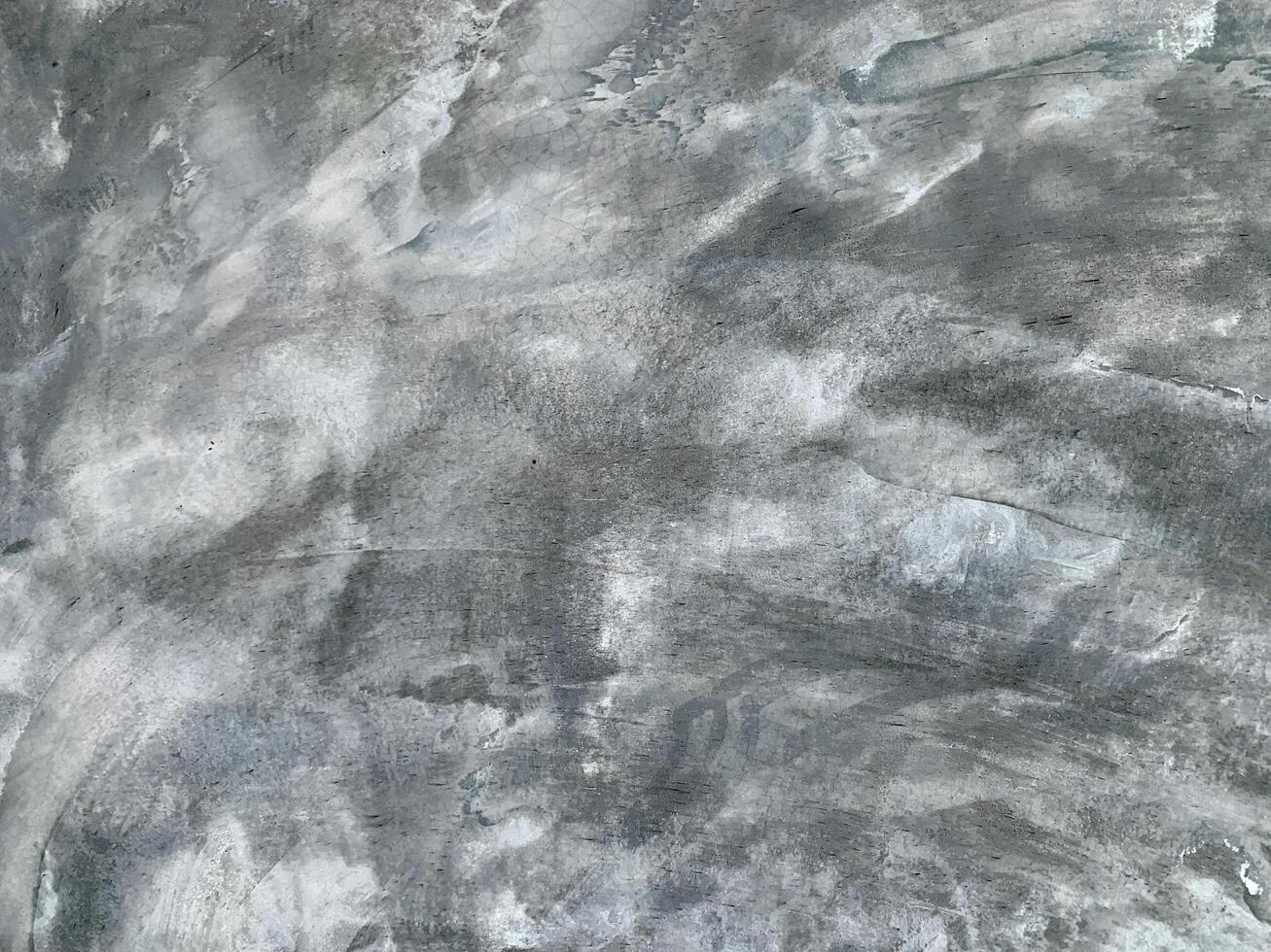 Rough concrete wall surface with natural gray abstract texture, ideal for background or design use. photo
