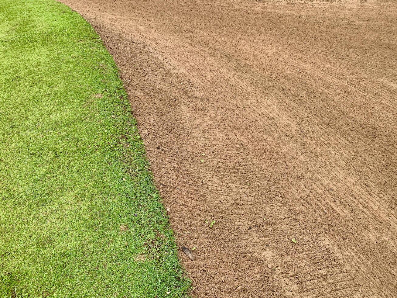 Golf Course Sand Pit Bunkers,green grass surrounding the beautiful sand holes is one of the most challenging obstacles for golfers and adds to the beauty of the golf course photo