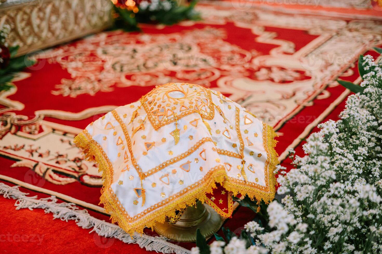 Elegant traditional fabric centerpiece with intricate golden embroidery photo