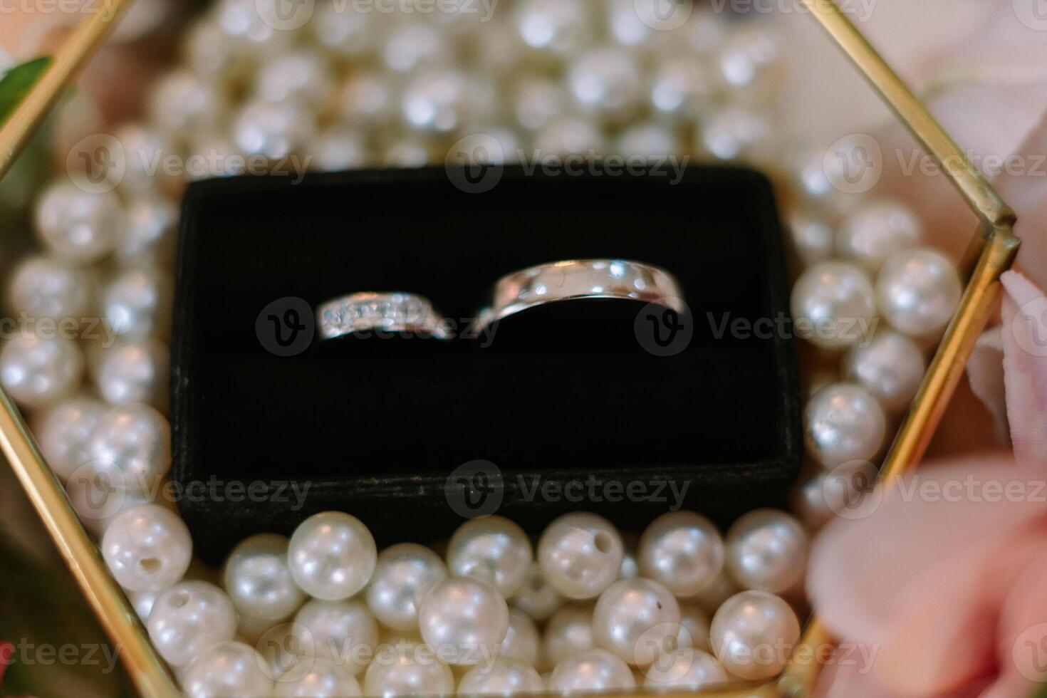 Elegant Wedding Rings Displayed with Pearls in Decorative Box photo