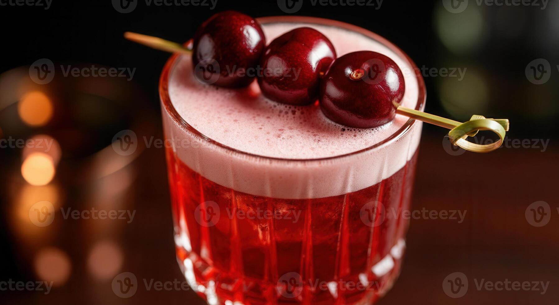Luxurious cocktail with dark red cherries on skewer in elegant glass photo