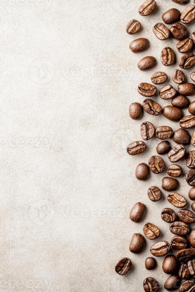 Roasted coffee beans arranged on right side of image. Beige textured surface. Empty space to left. Close up coffee background photo