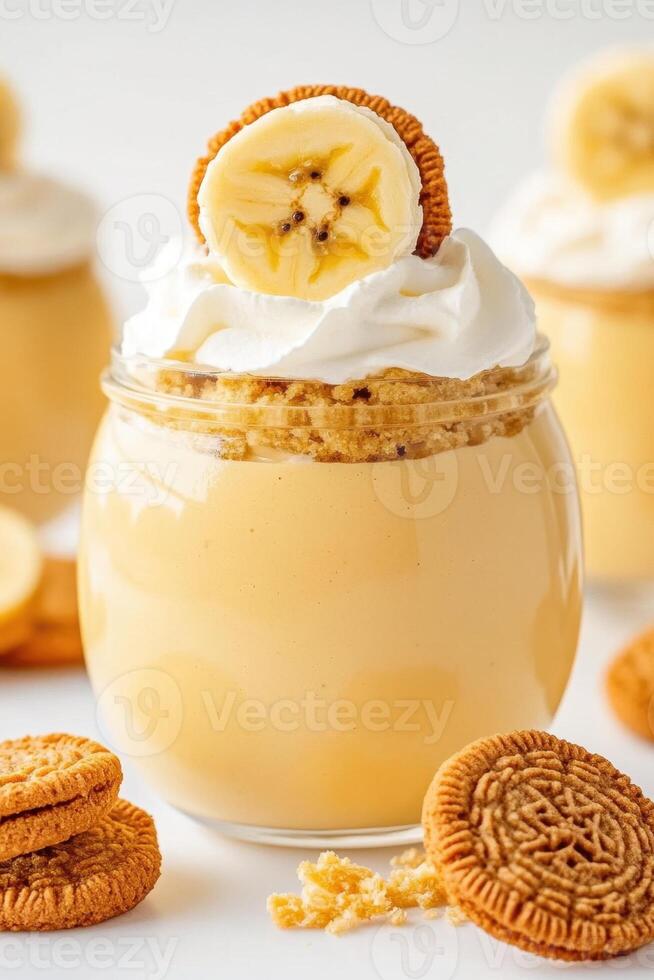 Banana Pudding Dessert in Glass Jar. Vanilla Cream with Fruit and Cookies. Sweet Vegetarian Treat on White Background. photo