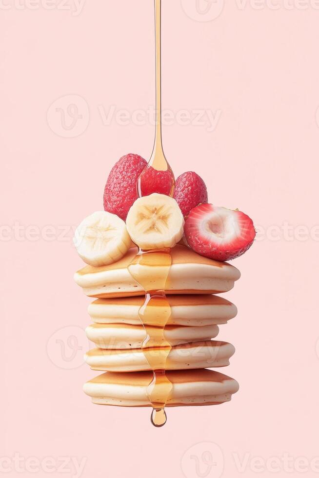 Stack of Pancakes Topped with Sliced Banana Strawberries Raspberries. Syrup Drizzles Down. Sweet Vegetarian Dessert on Pink Background. Delicious Food. photo