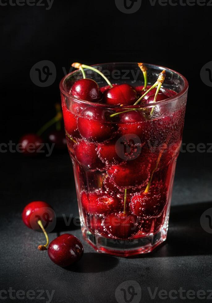 Refreshing cherry beverage with bubbles in glass on dark background photo