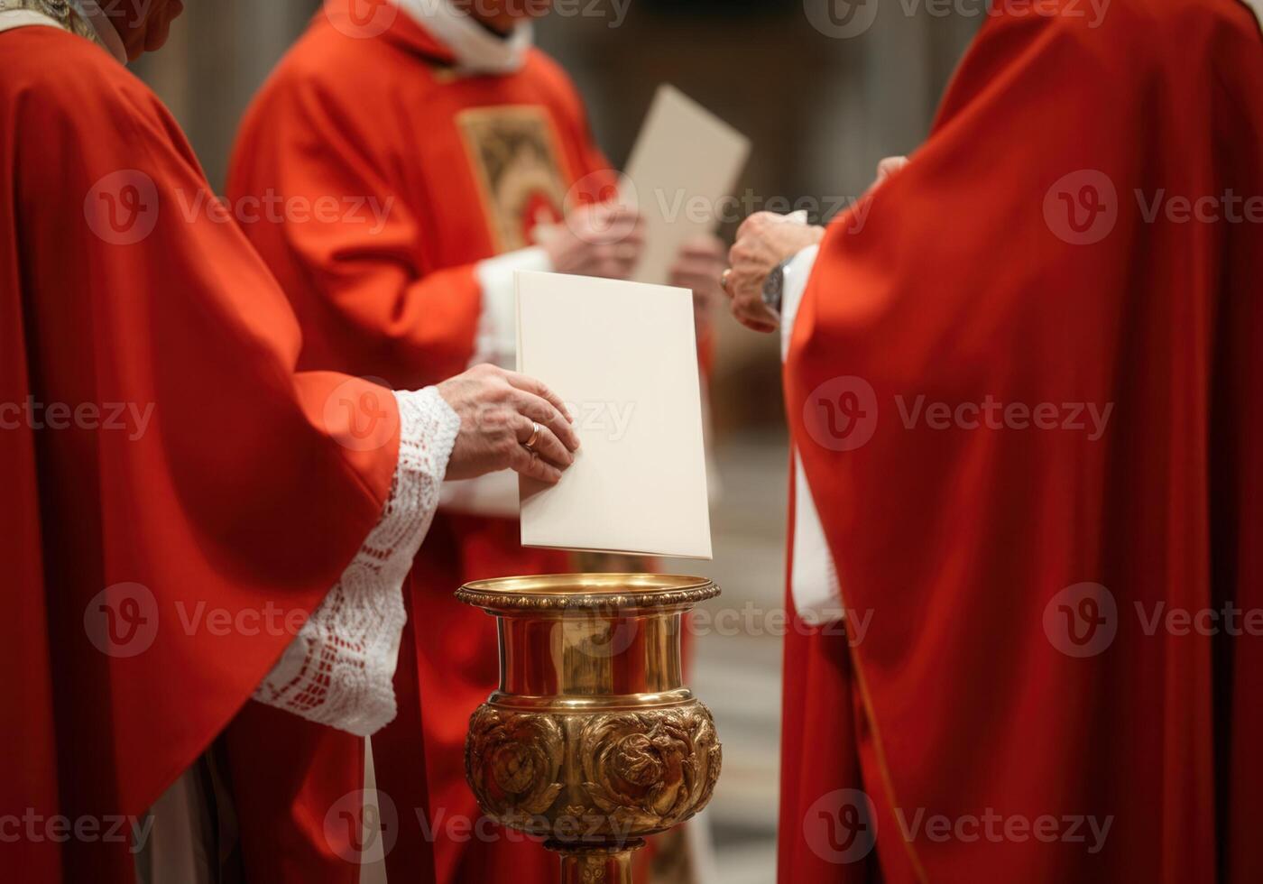 Clergy in red robes holding religious cards during ceremony photo