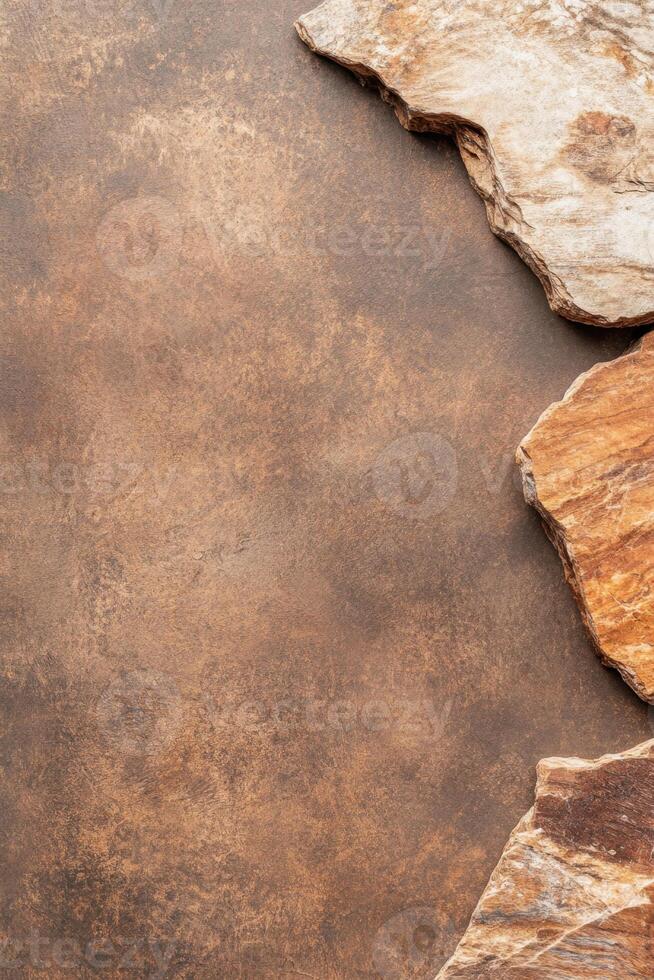 Brown textured background with natural stone fragments. Rock pieces lying on surface. Rough mineral material. Geology element. Rocky border with empty space. photo