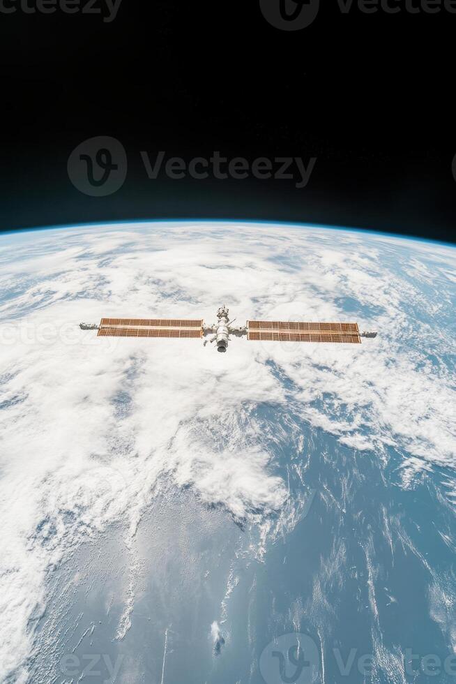 Orbiting structure above Earth. Space station with solar panels faces blue planet and cloudscape. Black space above planet surface showing curvature of planet. photo