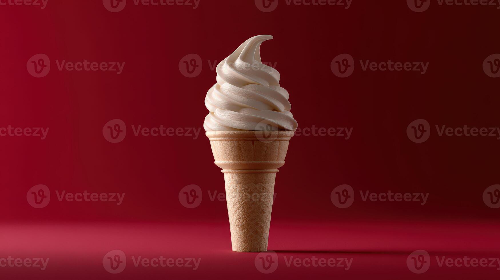Soft serve ice cream cone against a red background photo
