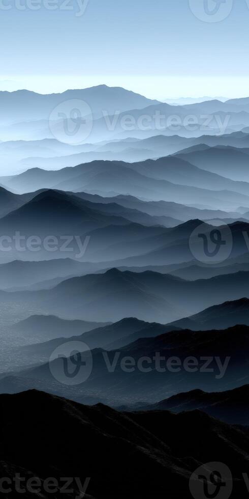 Expansive mountain range shrouded in mist at dawn photo