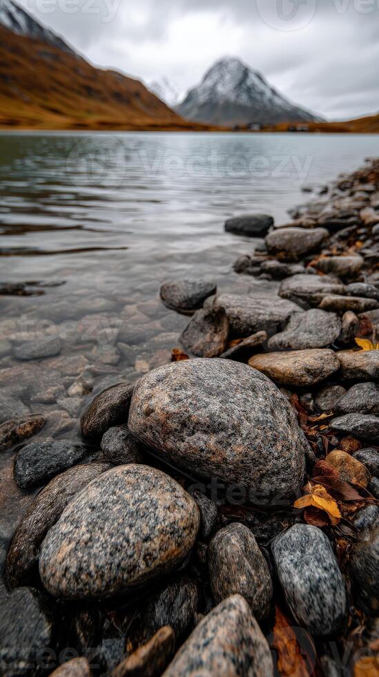 Rocky shoreline with tranquil water reflections photo