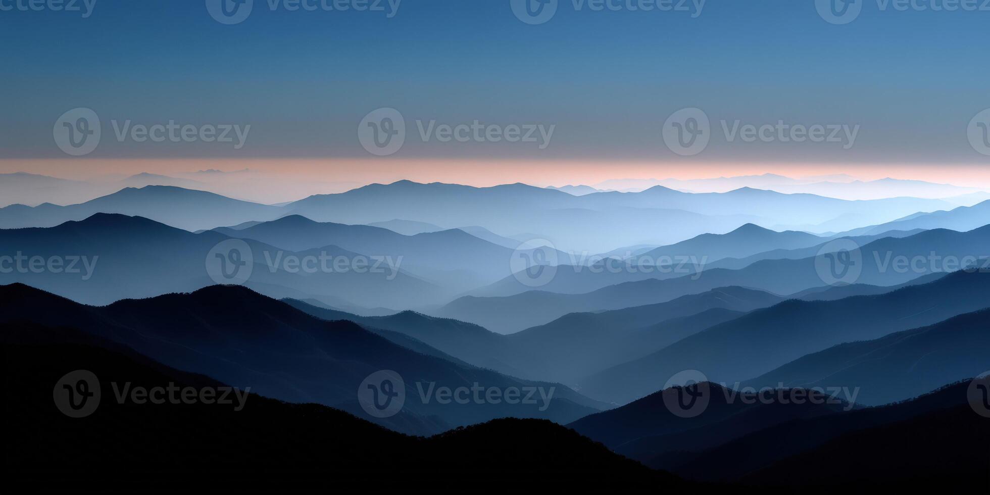 Majestic mountain range under twilight sky with soft haze photo