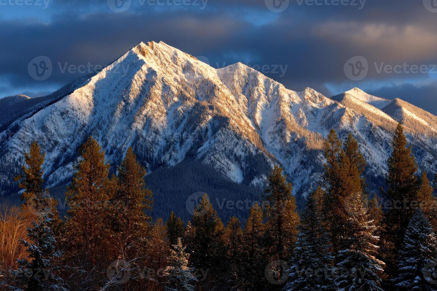 Snow-covered mountain peak under dramatic winter sky photo