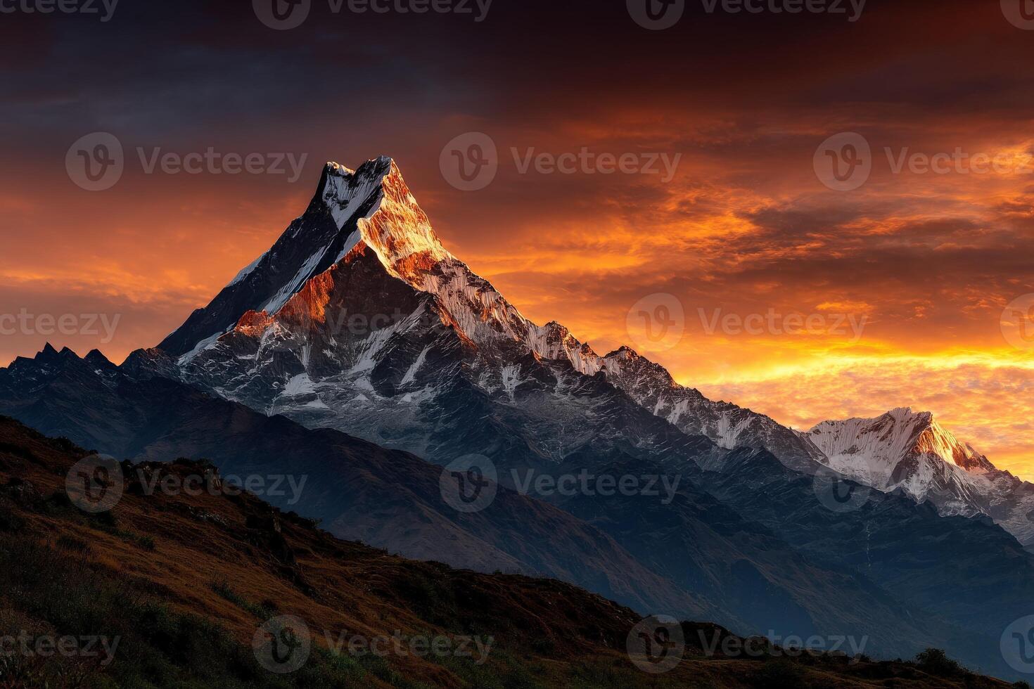 Mountain peak glows at sunset in the Himalayas photo