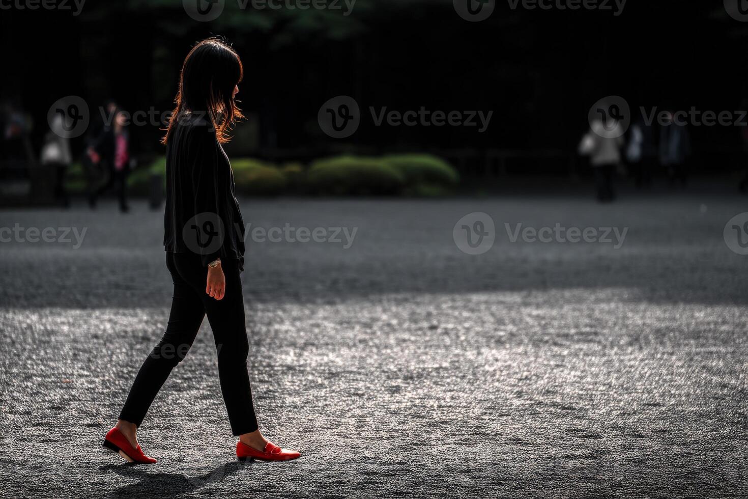Woman walking in a park during the day with sunlight photo