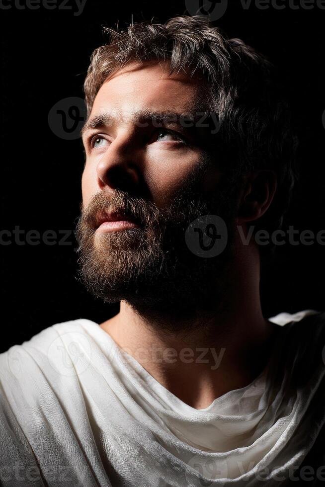 Stoic man with thoughtful expression against dark background photo